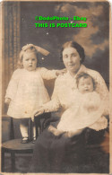 R408492 A Woman With Two Young Children Is Sitting On A Chair. Postcard - World