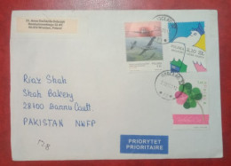 POLAND TO PAKISTAN USED COVER WITH STAMPS AEROPLANE FLOWERS CARTOON - Lettres & Documents