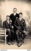 CARTE PHOTO NON IDENTIFIEE REPRESENTANT TROIS HOMMES TENANT LA POSE DANS UN STUDIO PHOTO - To Identify