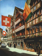 12257608 Appenzell IR Hauptgasse Ladengeschaeft Flaggen Appenzell - Sonstige & Ohne Zuordnung