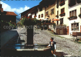 11896558 Gruyeres FR Dorfpartie Mit Brunnen Gruyeres - Andere & Zonder Classificatie