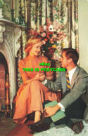 R574854 Woman And Man. Fireplace. Flowers. Book. 980 2 - Welt