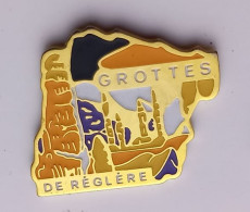 G313 Pin's Dinosaure Préhistoire Spéléologie Les Grottes De Réclère Jura Suisse Haute-Ajoie  Achat Immédiat - Ciudades