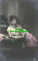 R603914 Two Little Girls Are Watching A Photo Album. Carlton Publishing. Rotopho - Welt