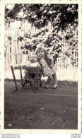 PHOTO DE 11 X 6.5 CMS UNE FILLETTE DEBOUT PRES D'UN BEBE DANS SA CHAISE HAUTE PLIEE MAI 1942 - Anonymous Persons