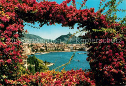 73246735 Como Lago Di Como Blumenranken Durchblick Zur Stadt Como Lago Di Como - Sonstige & Ohne Zuordnung