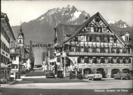 11642861 Kuessnacht Dorfplatz Mit Pilatus Autos Kuessnacht Am Rigi - Autres & Non Classés