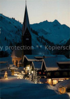 73176426 Mittelberg Kleinwalsertal Ortsmotiv Mit Kirche Zur Weihnachtszeit Winte - Andere & Zonder Classificatie