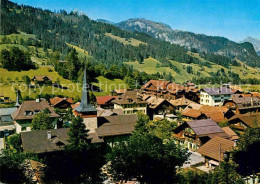 12758116 Gstaad Ortspartie Mit Kirche Gstaad - Sonstige & Ohne Zuordnung