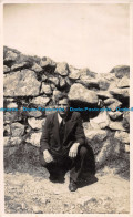 R062135 Old Postcard. A Man Near The Rocks Wall - World