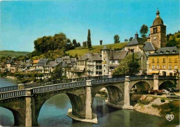 12 - Saint Geniez D'Olt - L'Eglise Le Pont Et Les Vieilles Maisons Au Bord Du Lot - CPM - Voir Scans Recto-Verso - Sonstige & Ohne Zuordnung