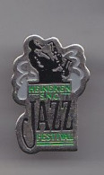 Pin's Heineken SCN Festival Jazz Joueur De Saxo Saxophone Réf 4749 - Muziek