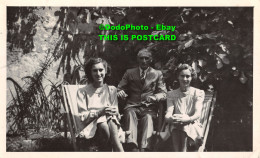 R346775 An Old Man In A Suit And Two Women Sitting On Chairs In The Garden. 1945 - World