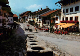 13600339 Gruyeres FR La Rue Pittoresque Avec Les Anciennes Mesures Gruyeres FR - Andere & Zonder Classificatie