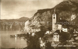 12587707 Flueelen UR Ortsansicht Mit Kirche Vierwaldstaettersee Gegen Axenstrass - Altri & Non Classificati