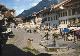 11888127 Gruyeres FR Dorfplatz Brunnen Gruyeres - Autres & Non Classés