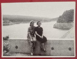 PH - Ph Original - Deux Femmes Assises Sur Un Petit Mur Avec Un Grand Lac Derrière - Anonieme Personen