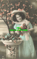 R586294 A Woman In A Hat Stands By A Flowering Tree And A Fountain. 1914 - Monde