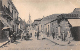 Algérie - N°89436 - SOUK AHRAS - La Rue De Madaure Et L'Eglise - Commerce, Au Gagne Petit, Bonneterie, Chapellerie - Souk Ahras