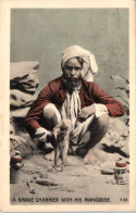 A Snake Charmer With His Mangoose - India