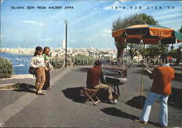 71708699 Tel Aviv Seen From Ancient Jaffa Artist In Painting Strassenmaler Tel A - Israel