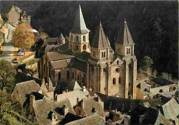 12 - Conques En Rouergue - Au Soleil Couchant L'abbatiale Ste Foy Veille Sur Les Toits Gris - Carte Neuve - CPM - Voir S - Andere & Zonder Classificatie