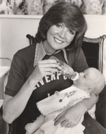 Cilla Bottle Feeding Baby In Liverpool Jumper Press Photo - Photographs