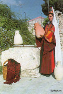 Bethlehem - A Palestinian Woman In Her Traditional Costume Filling A Jar - Israel