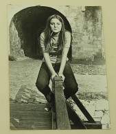 A Teenage Girl Sits On The Railing Of A Bridge - Anonymous Persons