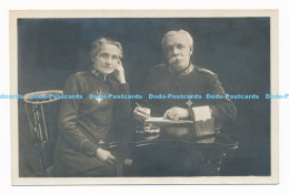 C000901 An Old Man In A Uniform And A Woman Sitting At A Table - Monde
