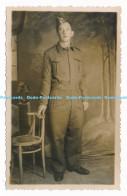 C000912 A Young Man In Uniform Is Standing By A Chair - Monde