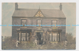 C007784 House. Unknown Place. People In The Front Of The House - World